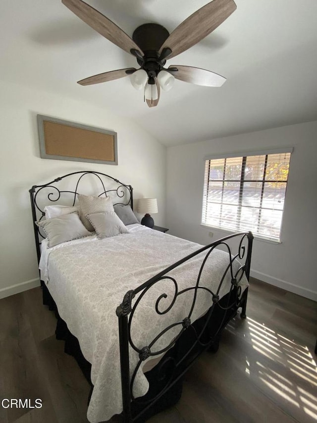 bedroom with ceiling fan, lofted ceiling, and dark hardwood / wood-style floors