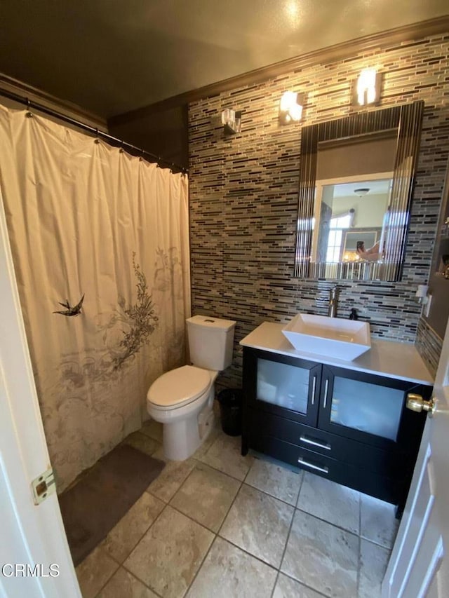 bathroom featuring toilet, a shower with curtain, tile patterned floors, and vanity