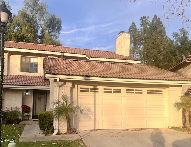 mediterranean / spanish home featuring a garage