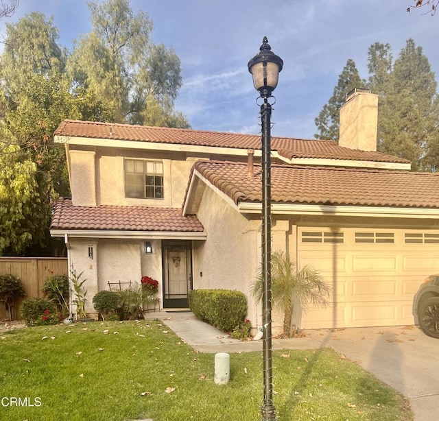 view of front of property with a front yard and a garage