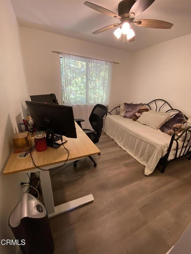 bedroom with ceiling fan and hardwood / wood-style floors