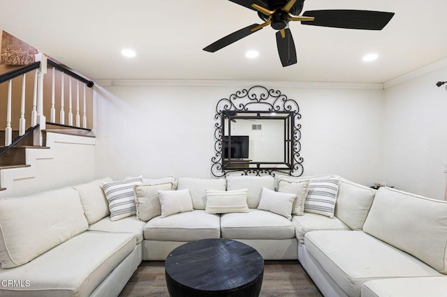 living room with stairs, recessed lighting, wood finished floors, and ornamental molding