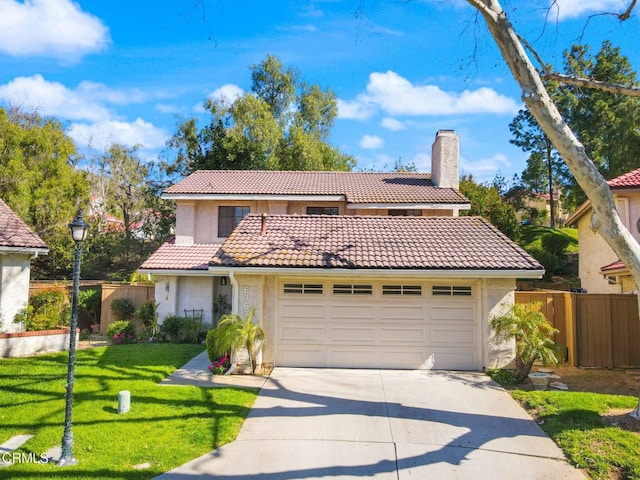 view of front of home with a chimney, an attached garage, a tile roof, and fence