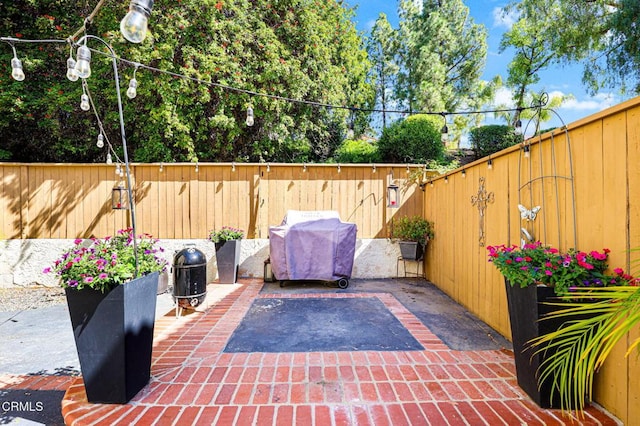 view of patio with grilling area and a fenced backyard