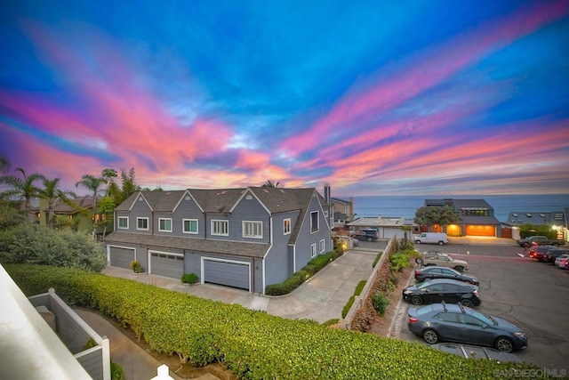 view of front of home featuring a garage and a water view