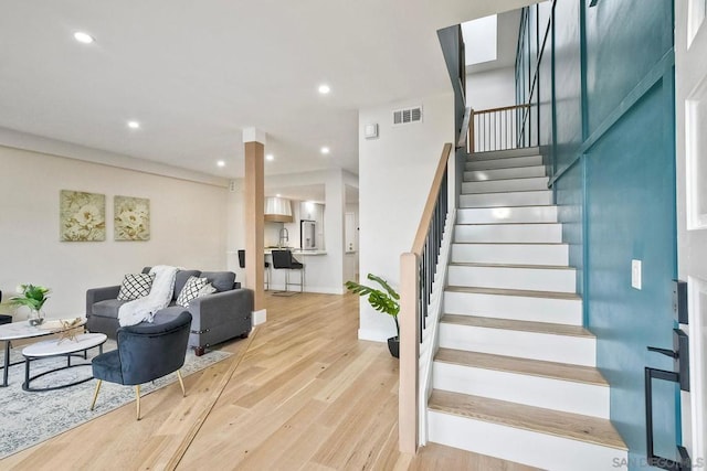 stairs featuring hardwood / wood-style floors