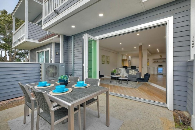 view of patio / terrace featuring ac unit, an outdoor hangout area, and a balcony