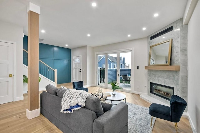 living room with a fireplace and light hardwood / wood-style flooring