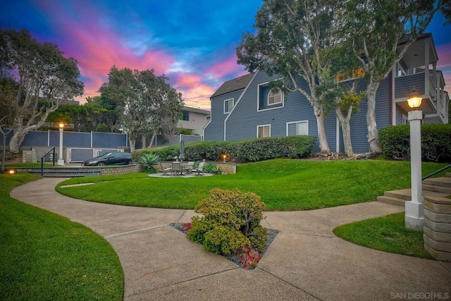 view of community with a yard and a patio area