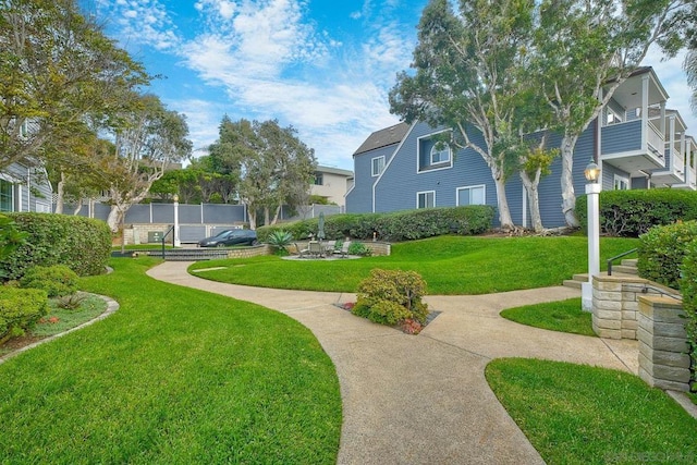 view of home's community with a yard