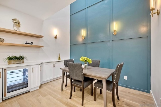 dining area featuring light hardwood / wood-style flooring and beverage cooler