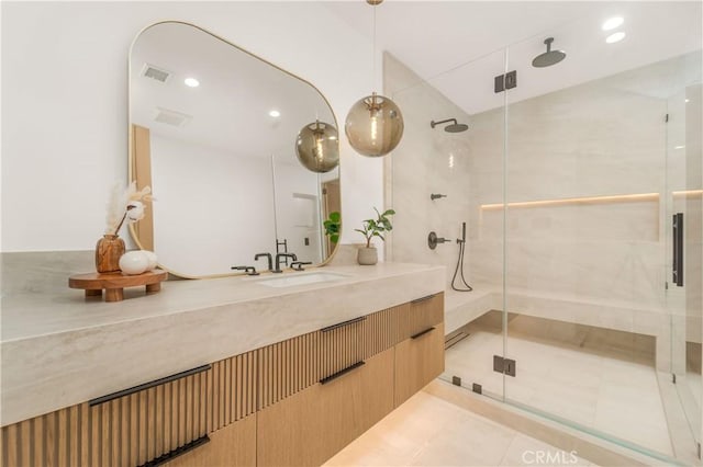 bathroom featuring vanity, tile patterned flooring, and a shower with door