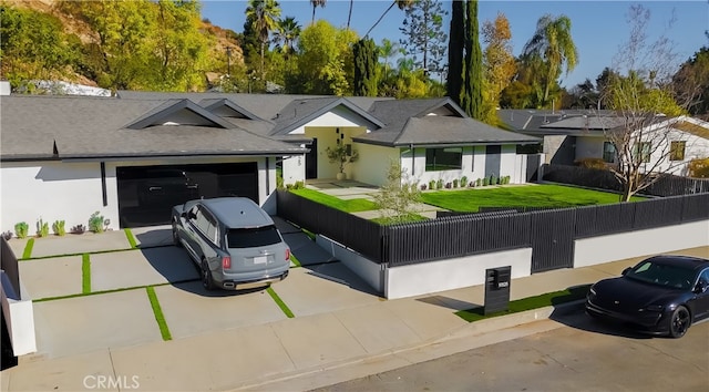 ranch-style home featuring a front yard and a garage