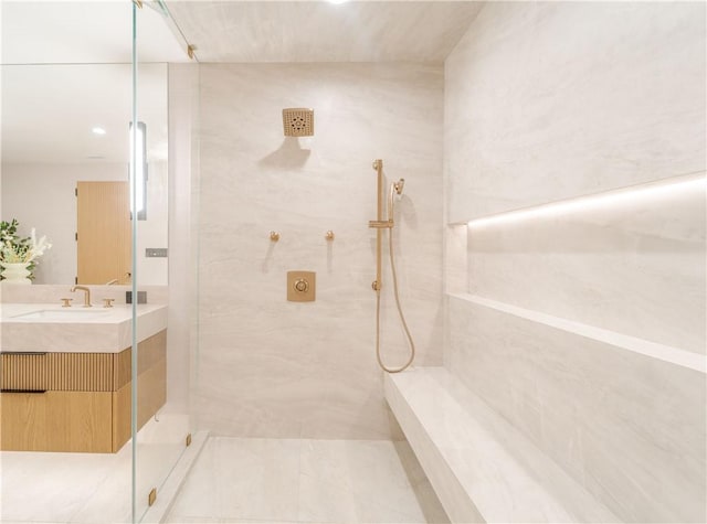 bathroom featuring vanity and a tile shower