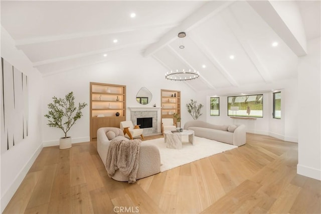 living room with a high end fireplace, built in features, light hardwood / wood-style flooring, and lofted ceiling with beams