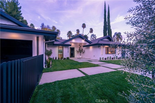 view of front facade with a yard and a garage