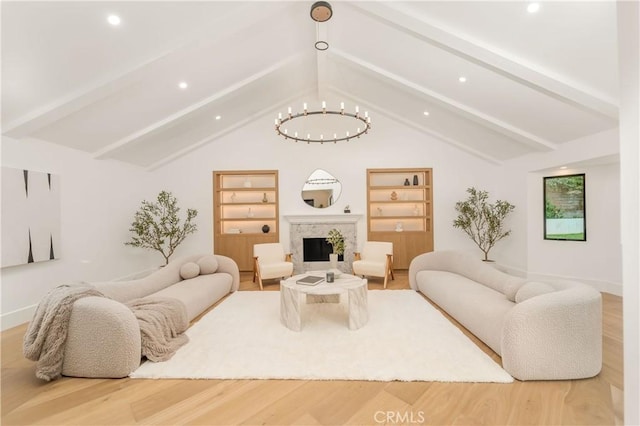 living room with vaulted ceiling with beams, built in features, hardwood / wood-style floors, and a notable chandelier