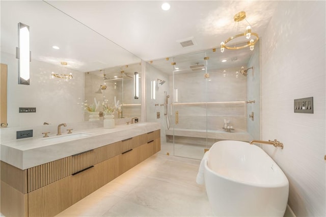 bathroom with tile walls, shower with separate bathtub, vanity, and an inviting chandelier