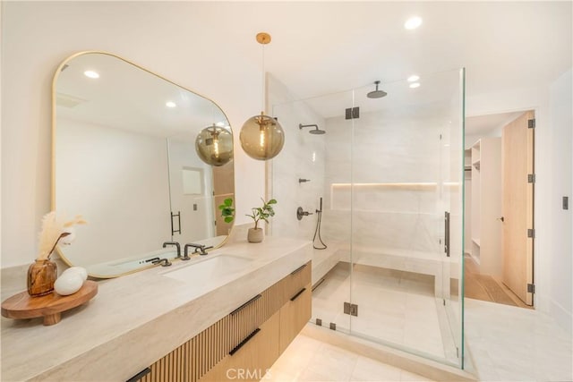 bathroom featuring vanity and a shower with door