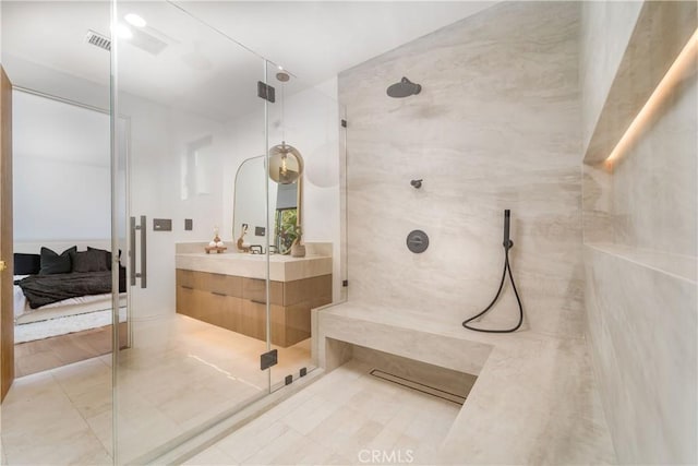 bathroom featuring vanity and an enclosed shower