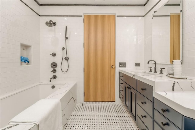 bathroom with tile walls, tiled shower / bath combo, and vanity