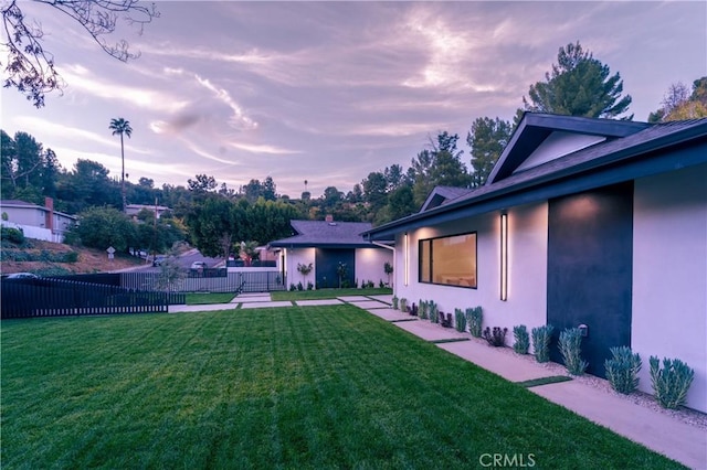 view of yard at dusk