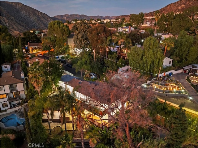 aerial view at dusk featuring a mountain view