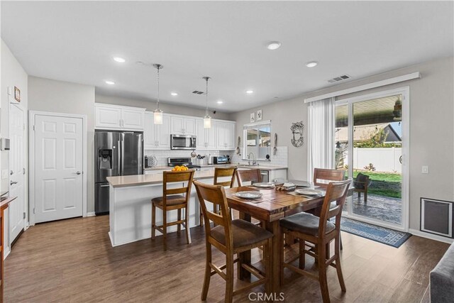 dining space featuring dark hardwood / wood-style floors