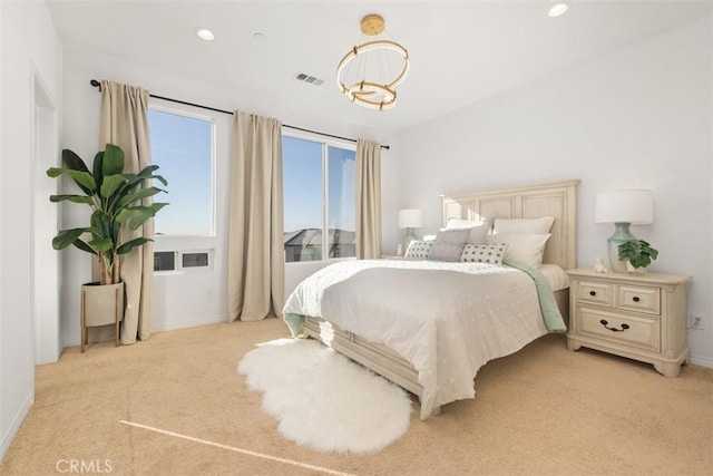 carpeted bedroom featuring a notable chandelier