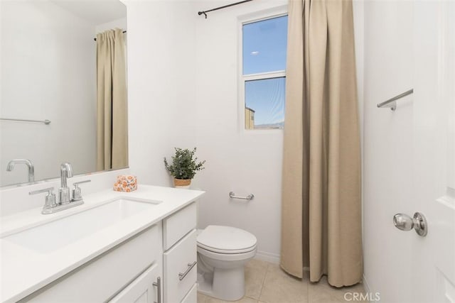 bathroom featuring toilet, vanity, and tile patterned flooring