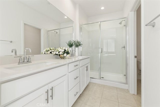 bathroom featuring vanity, toilet, tile patterned floors, and walk in shower