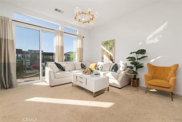 living room featuring light colored carpet and a notable chandelier