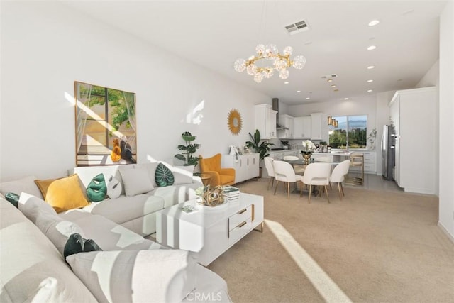 living room featuring light carpet and a notable chandelier