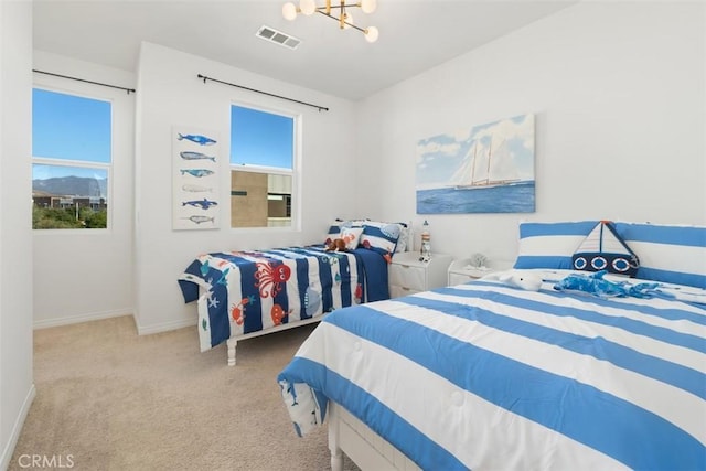 bedroom with light carpet and a chandelier