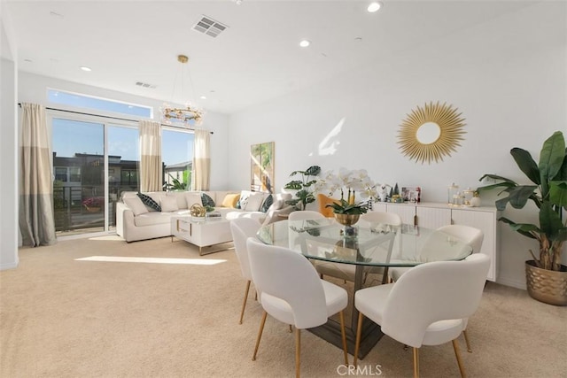 dining space with light colored carpet