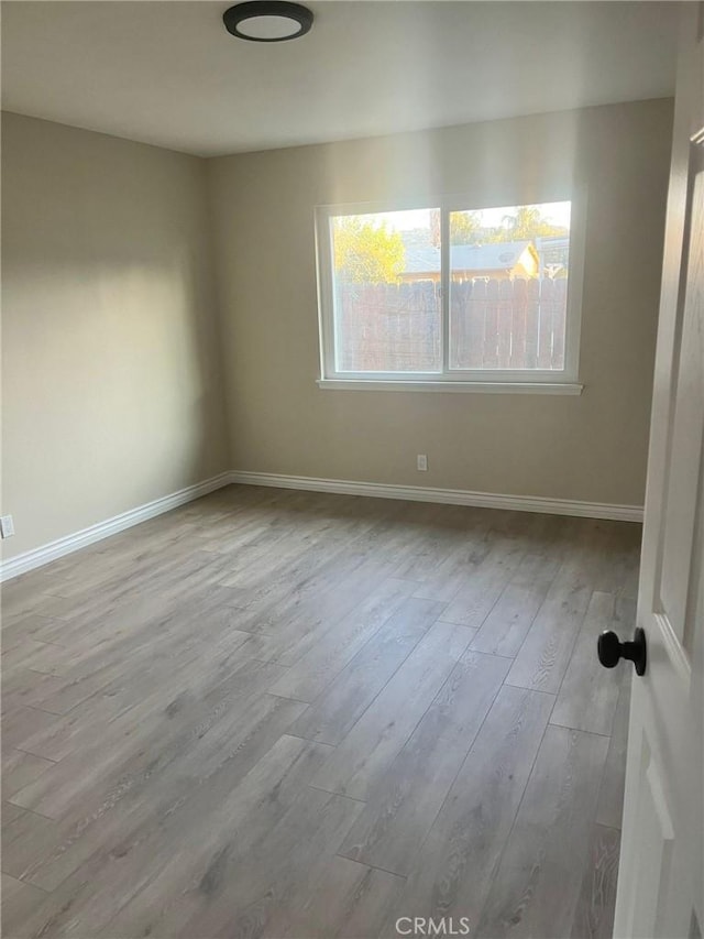 spare room with light hardwood / wood-style flooring