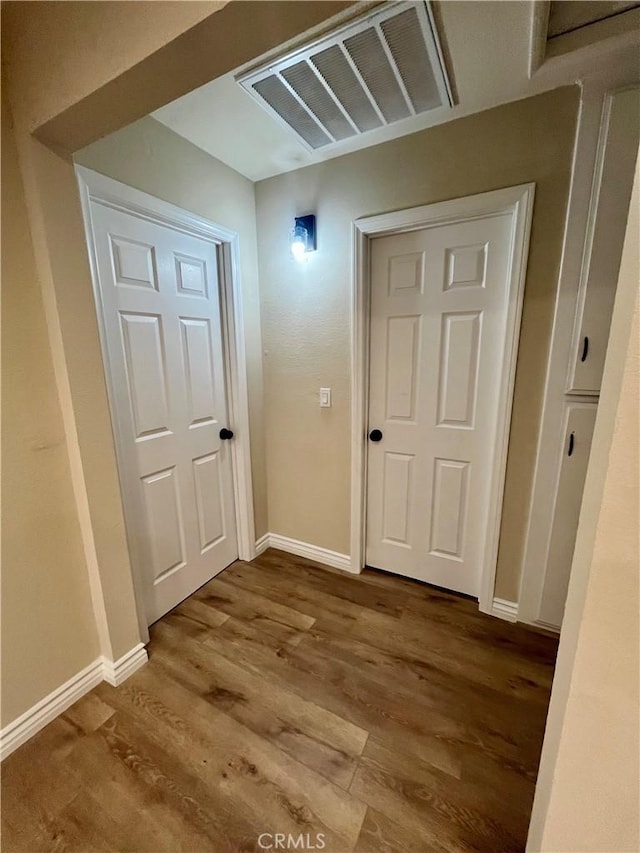 corridor with wood-type flooring