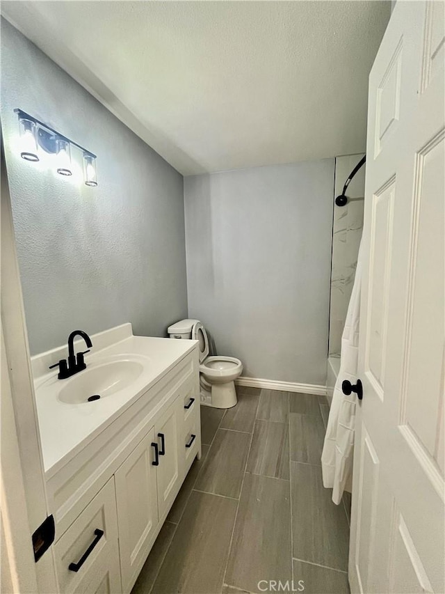 full bathroom featuring shower / tub combo, vanity, and toilet