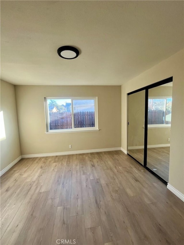 unfurnished room with light hardwood / wood-style floors