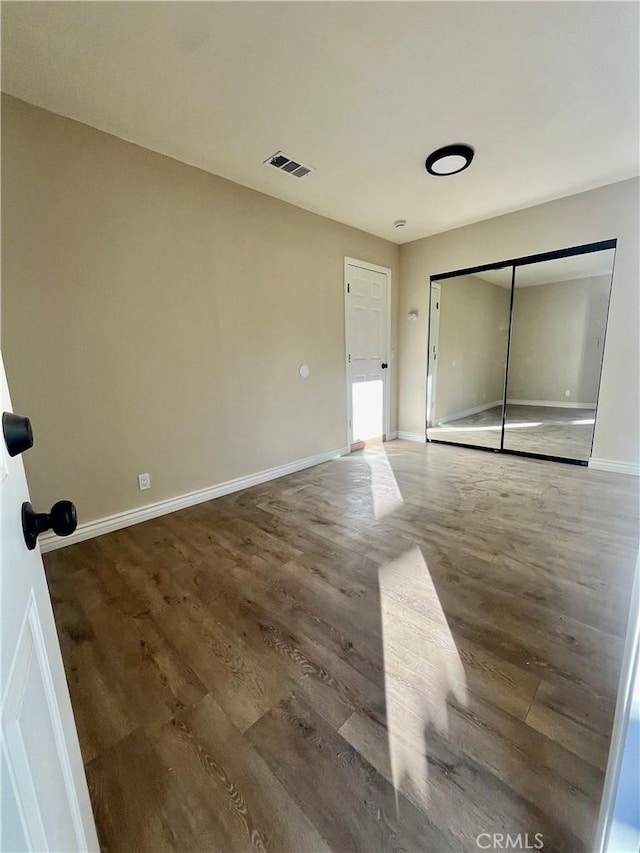 unfurnished room with hardwood / wood-style flooring