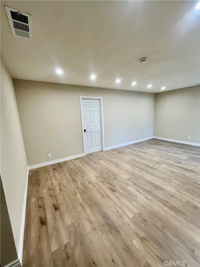 basement with light hardwood / wood-style floors