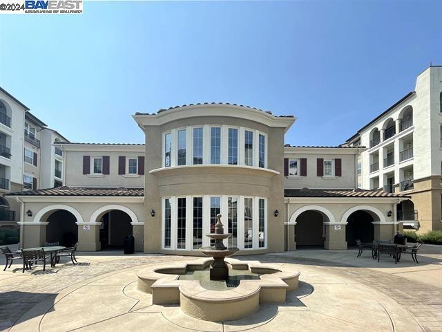 rear view of property featuring a patio area and french doors