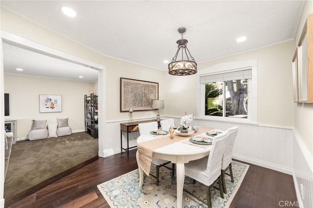 dining area with dark hardwood / wood-style floors and ornamental molding