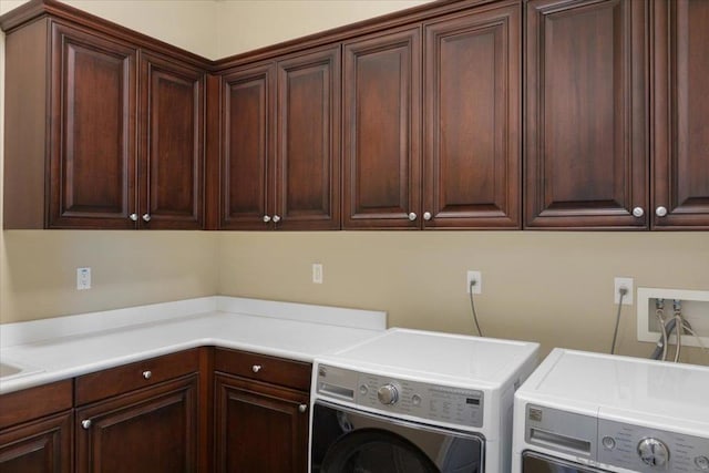 laundry room featuring cabinets and washing machine and clothes dryer