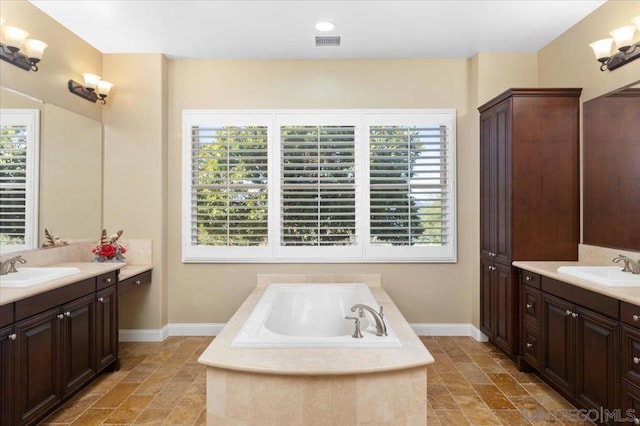 bathroom featuring vanity and a bath