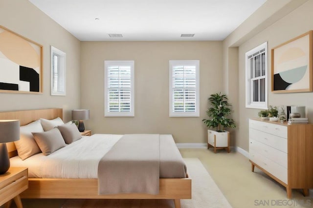 bedroom featuring light carpet