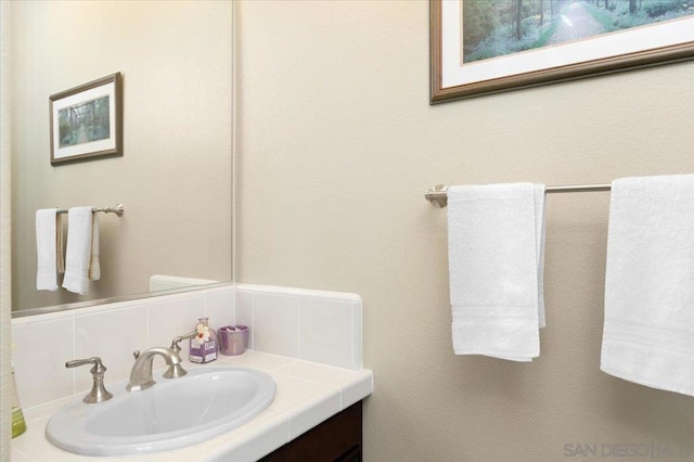 bathroom with backsplash and vanity