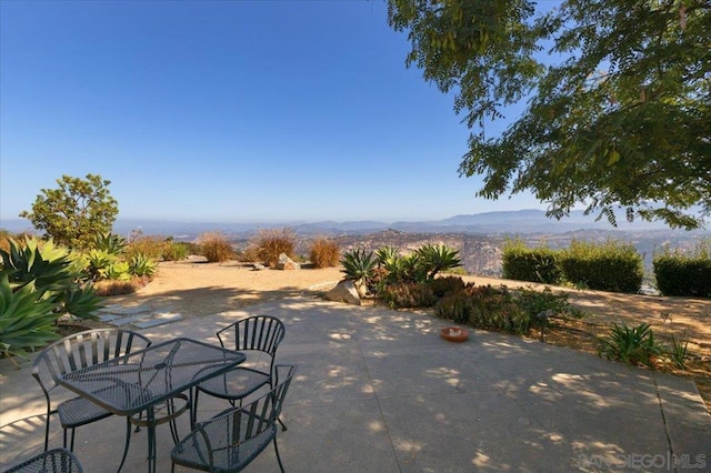 view of patio / terrace featuring a mountain view