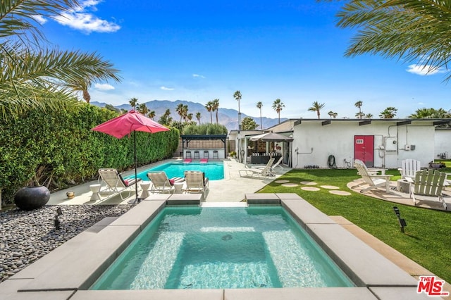 view of pool featuring a patio area and a mountain view