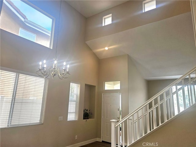 foyer entrance featuring a high ceiling and a notable chandelier